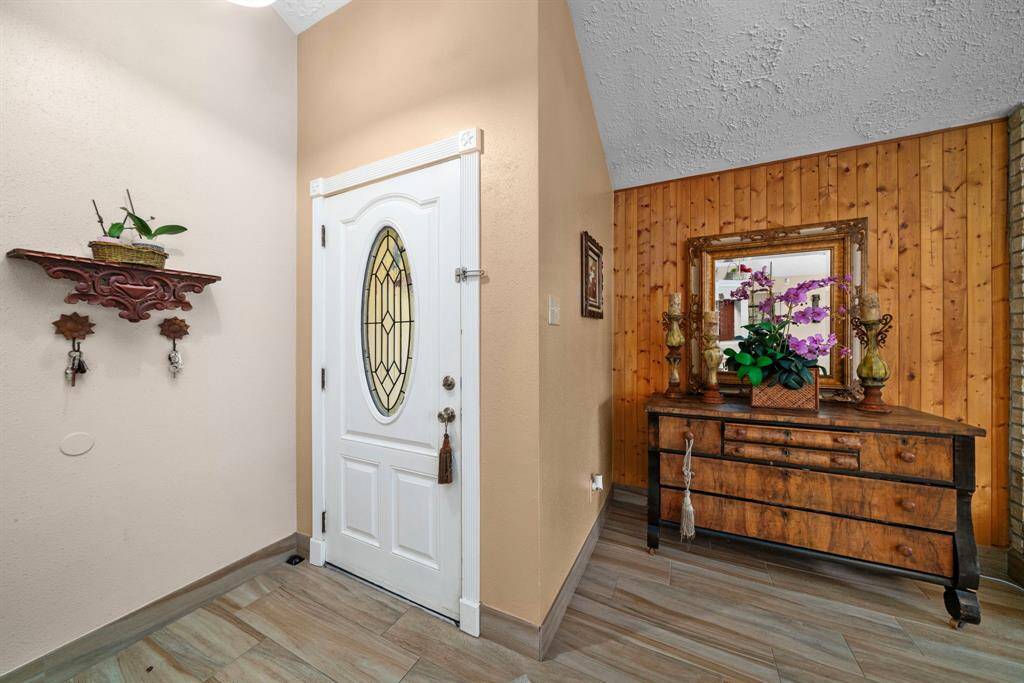 The home welcomes you into a cozy and bright living room, complete with a large fireplace.
