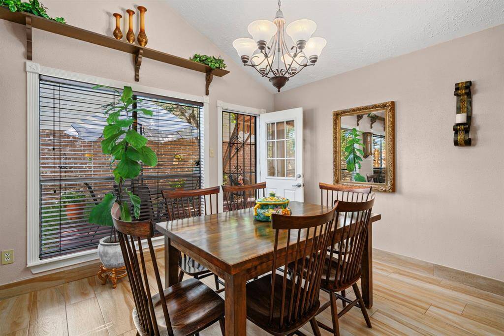 Living room opens into the dining room with large picture windows. This rooms offers access to a spacious wooden deck through the side entrance.
