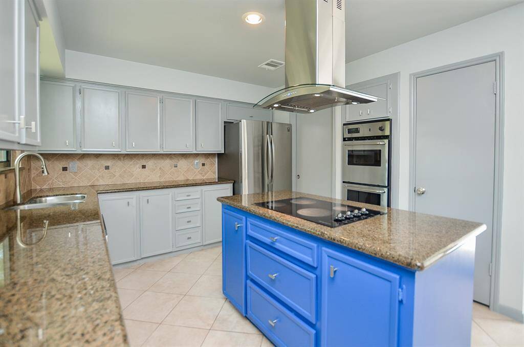 What could you dish up in this updated open kitchen?  Great prep, storage space and cooktop access from both sides of the island.