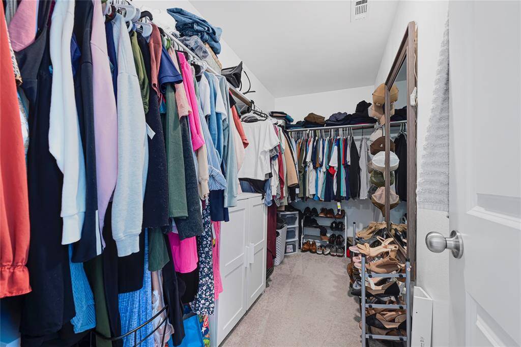 Generous walk-in closet with plenty of space for storage and organization.