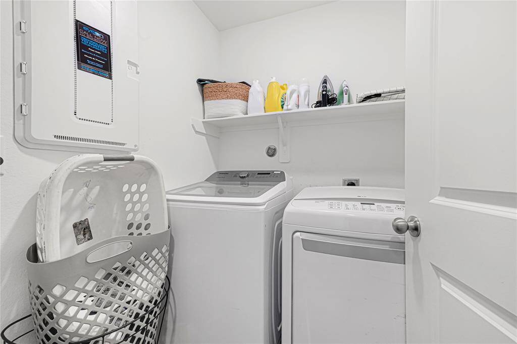 Convenient upstairs laundry room with storage and easy access to bedrooms.