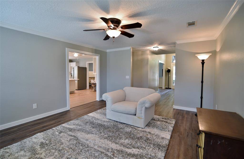 Another view of the gathering space with its crown molding and vinyl plank flooring.....