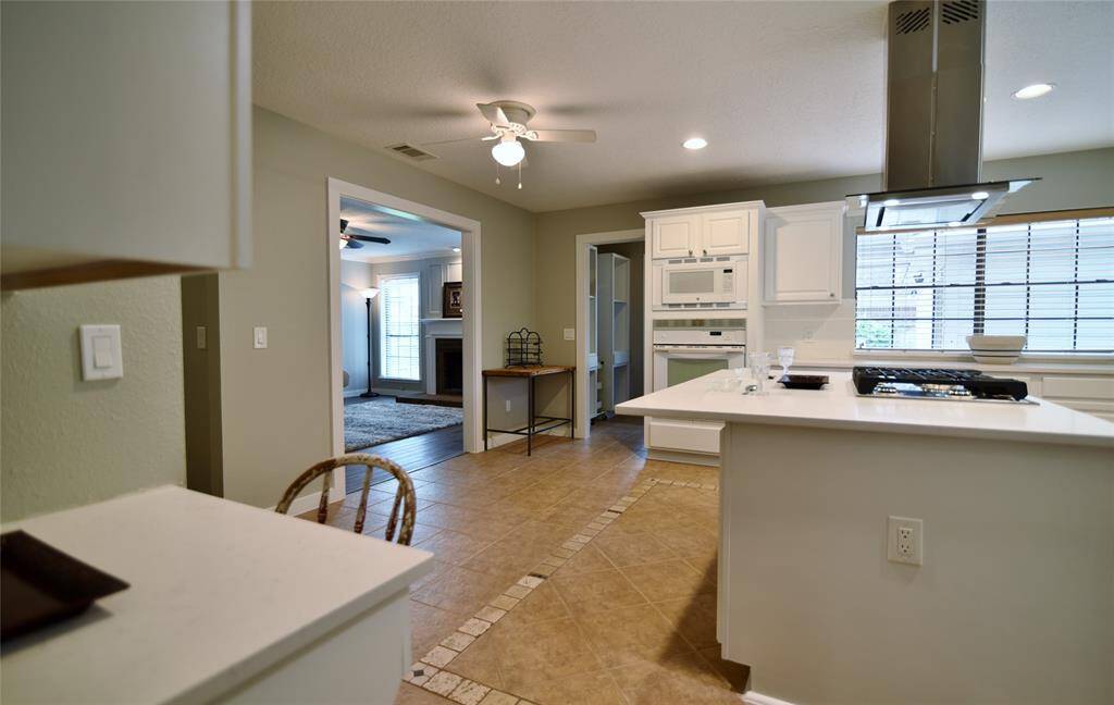 Coming from the dining room into the kitchen area.....small built-in planning area on the left makes a nice additionn to the kitchen area....