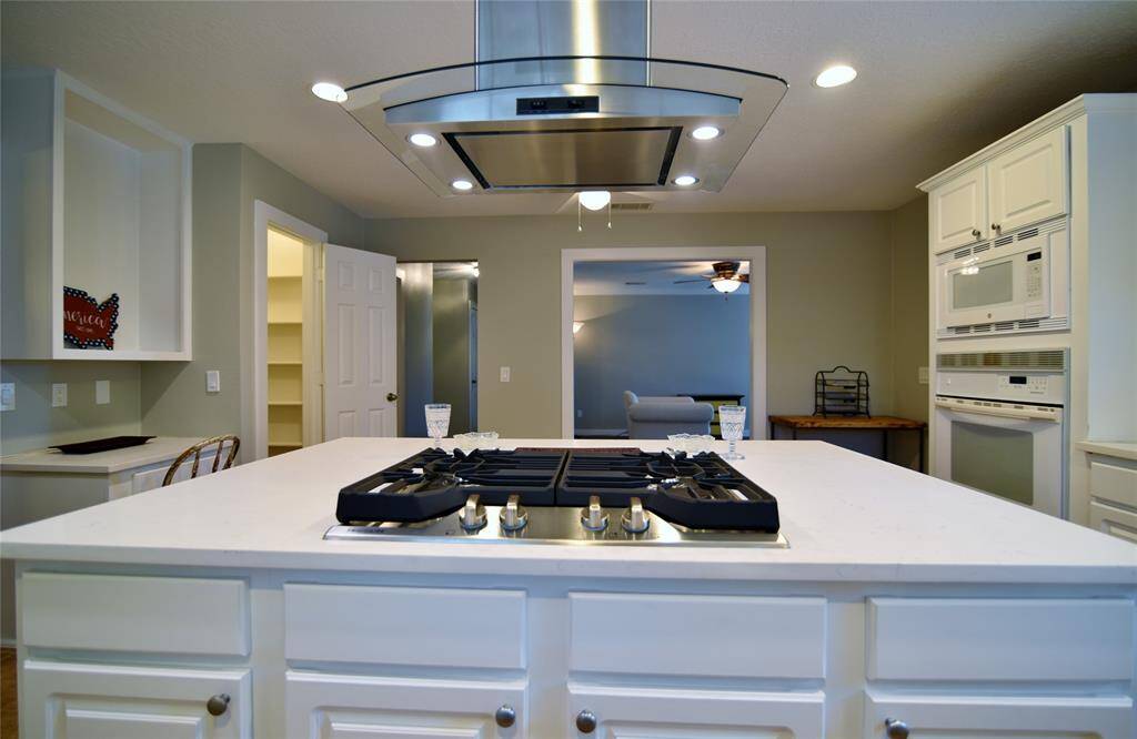 New gas cooktop has been added, with a streamlined, vented hood....