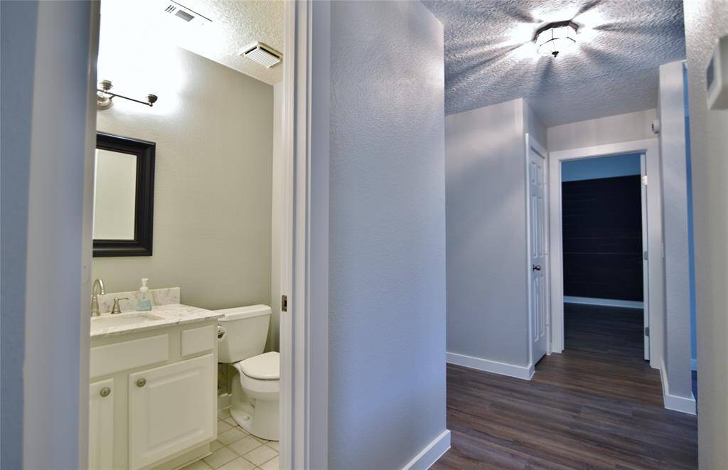 Just to the right of the kitchen is a conveniently placed powder bath which has updated counters, mirror and lightign....