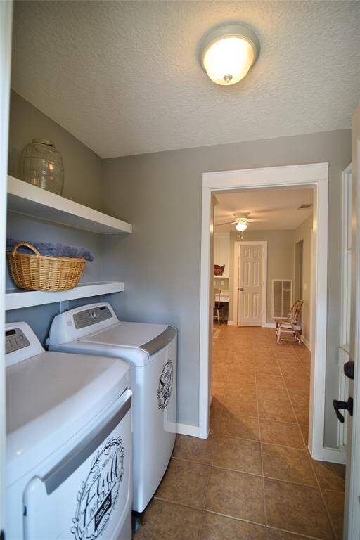 Located off of the kitchen area is a spacious utility room with built-in shelving....washer and dryer will remain for you....