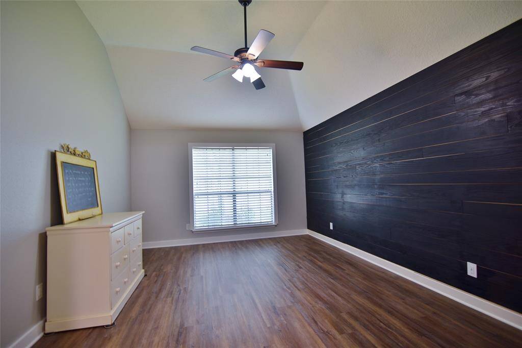 Primary suite is located on the first floor with the extended vinyl plank flooring and lighted ceiling fan....