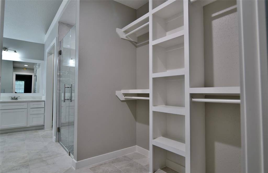 Primary bath is a welcome retreat to a busy day, or a spacious area in which to get ready to start your day....customized shelving just to the right as you enter.....