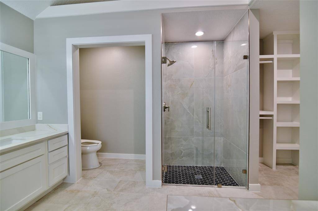 Separate toilet area and a glassed in shower complete the space....