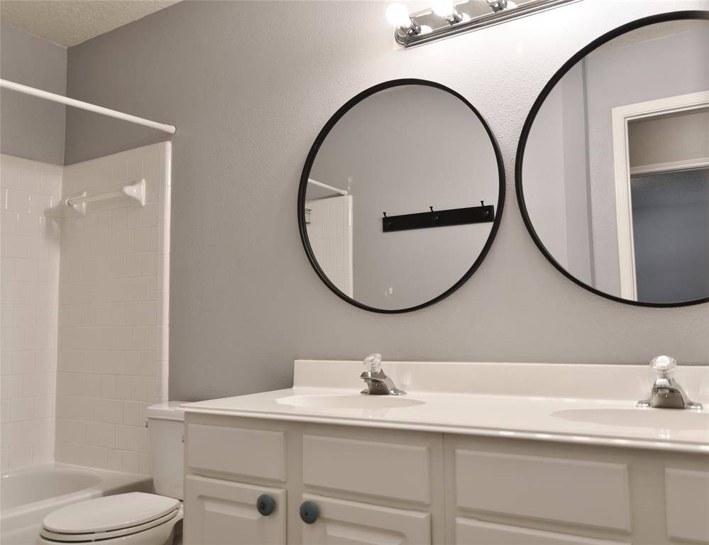 Hall bath with double sink and a tub/shower combo....