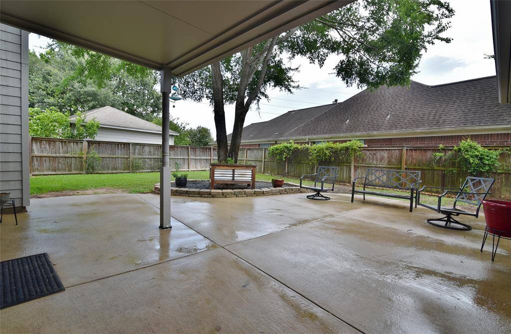 Great space in this back yard with mature tree, lined landscape beds and ample seating areas.....