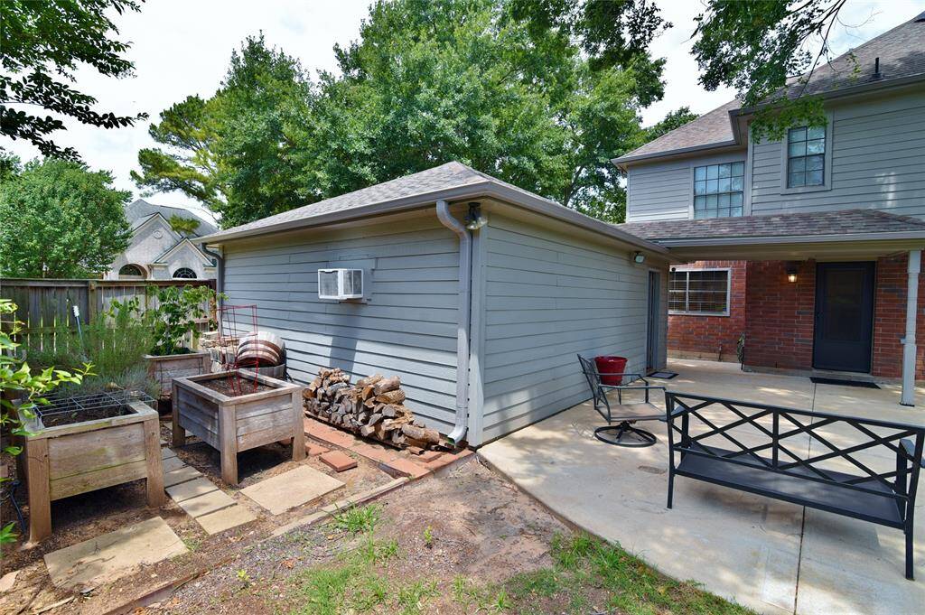 Behind the air conditioned garage/shop area is nice space in which to garden with built-in raised, garden beds already in place for you....