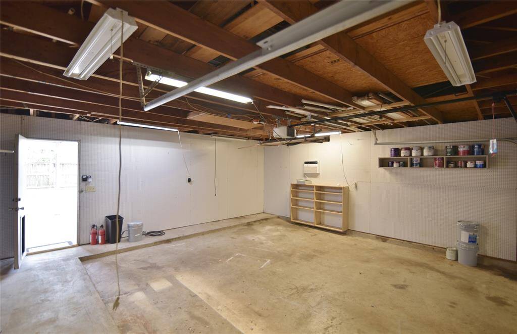 Garage area with peg board, extra lighting....plenty of room for parking or to use as a Texas basement!