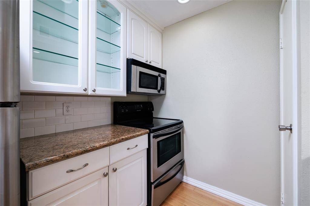 Lighted  cabinets and stainless steel appliances are a nice touch in the kitchen.
