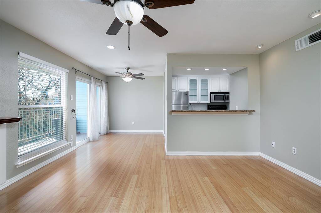 Another angle of the main living area looking towards kitchen and one of the balconies.