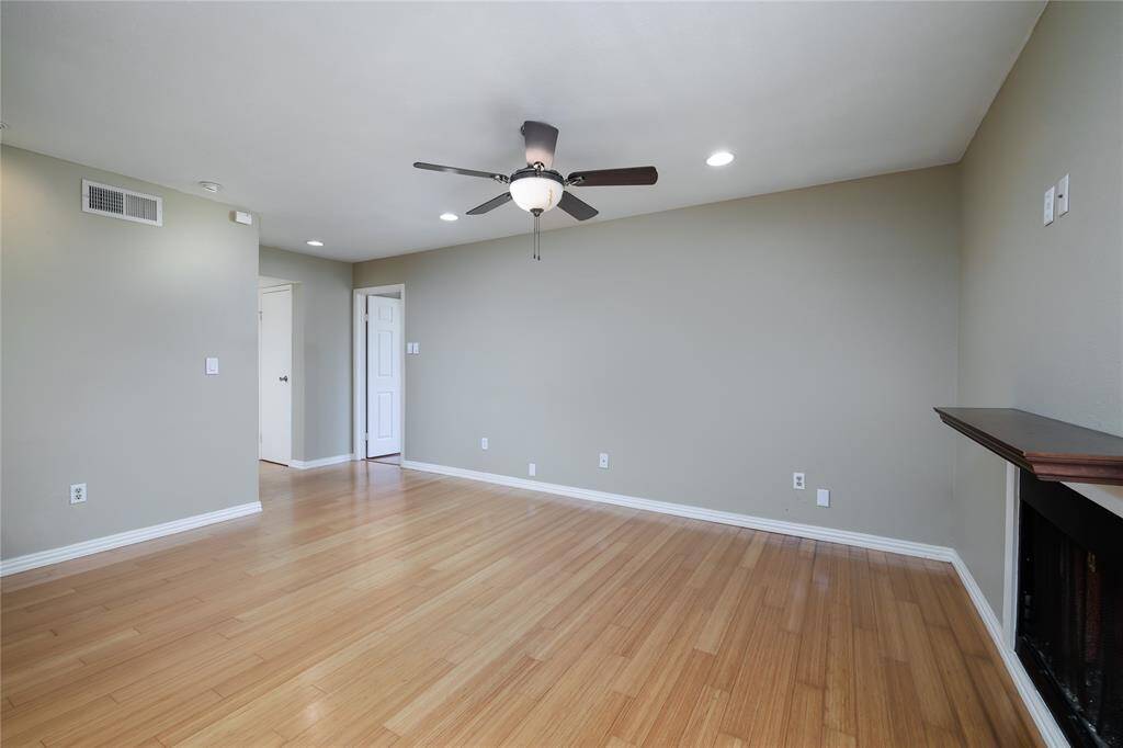 Wood mantle above fireplace in main living area.