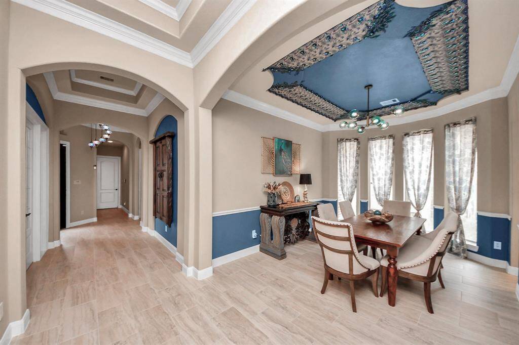 Dining room with designer ceiling and lighting located across from Wine Room and Office.