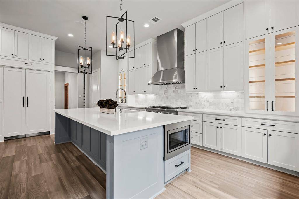 Soft close doors and drawers, under cabinet lighting, glass door fronts with lighted open shelved cabinets, and convenient door hardware.