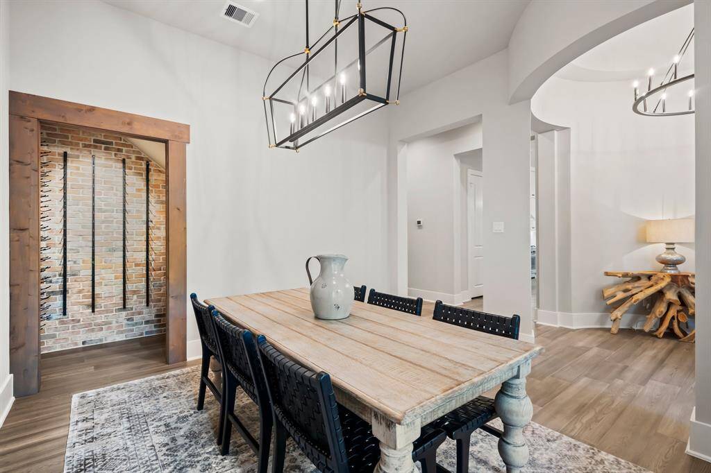 Formal dining with wineroom featuring quaint brick styling