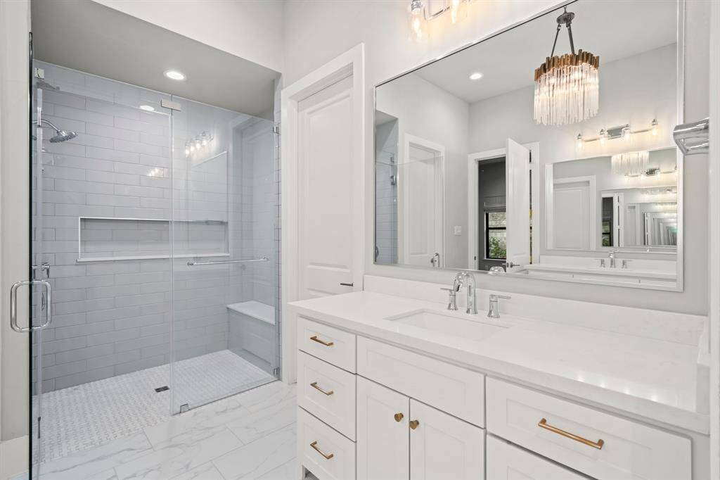 Convenient zero entry walk-in shower with frameless glass