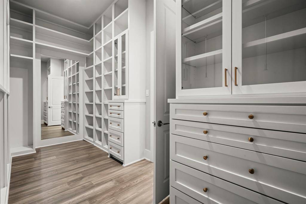 Excellent storage in the primary closet with seasonal rods and drawers