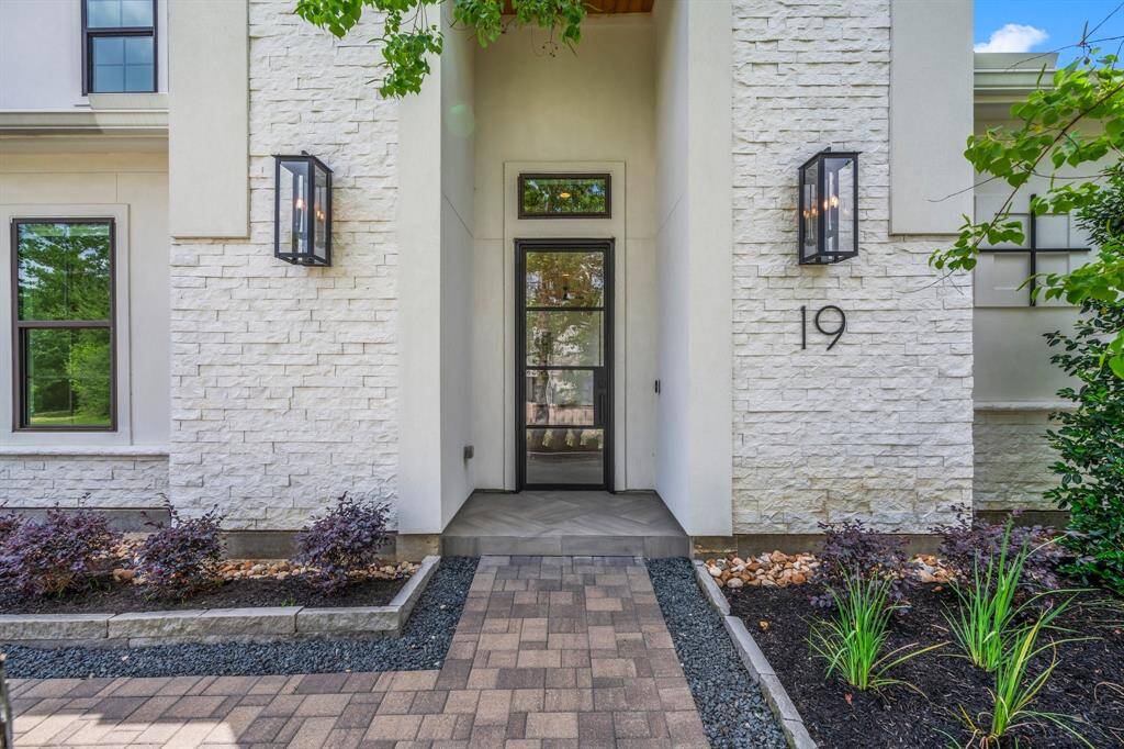 A modern and yet inviting stacked stone and stucco entrance