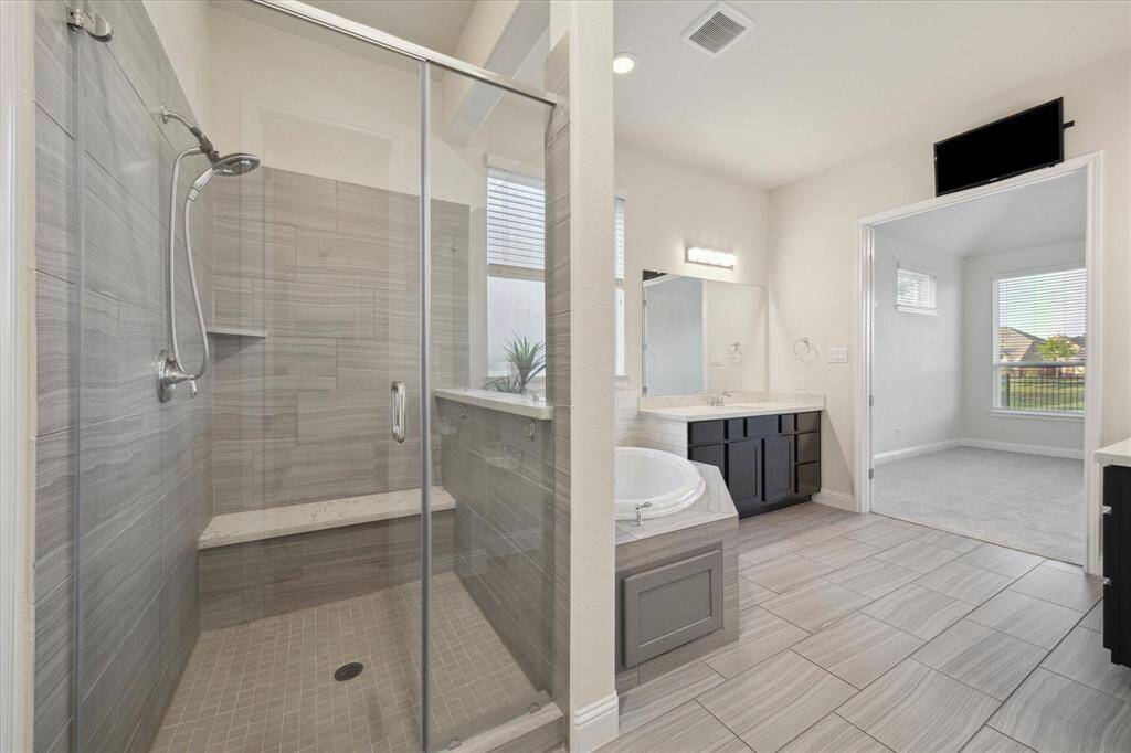 Elegant spa-inspired frameless shower that creates a seamless, modern look.