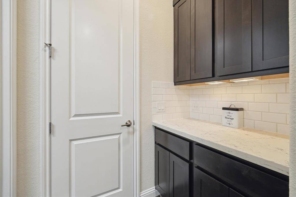 Additional storage and landing space across from the laundry room with access to the 2nd primary closet.