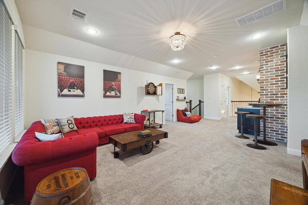 Entertaining is easy with this spacious game room and custom wet bar complete with more surround sound!