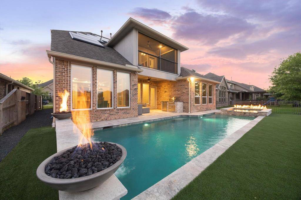 The backyard is fully turfed and black stone graveled on the sides.