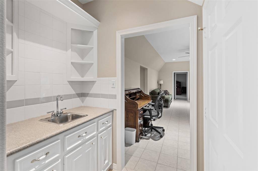 Cheers to convenience! This handy wet bar comes complete with a sink and plenty of storage, perfect for mixing cocktails, pouring wine, or just keeping the good times flowing.