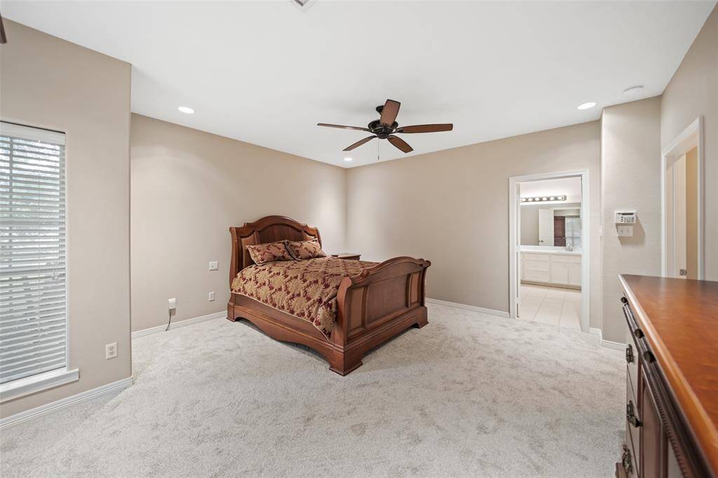 This private owner’s retreat is a great space to begin and end your day. This suite offers plush carpet, neutral paint, a raised ceiling with a lit fan and recessed lights, a large walk-in closet, and a luxurious ensuite spa-like bath.