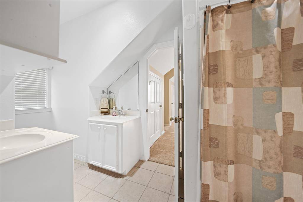 Designed with both family and guests in mind, this full bathroom features dual vanities for easy morning routines and a convenient tub/shower combo for versatile everyday use.