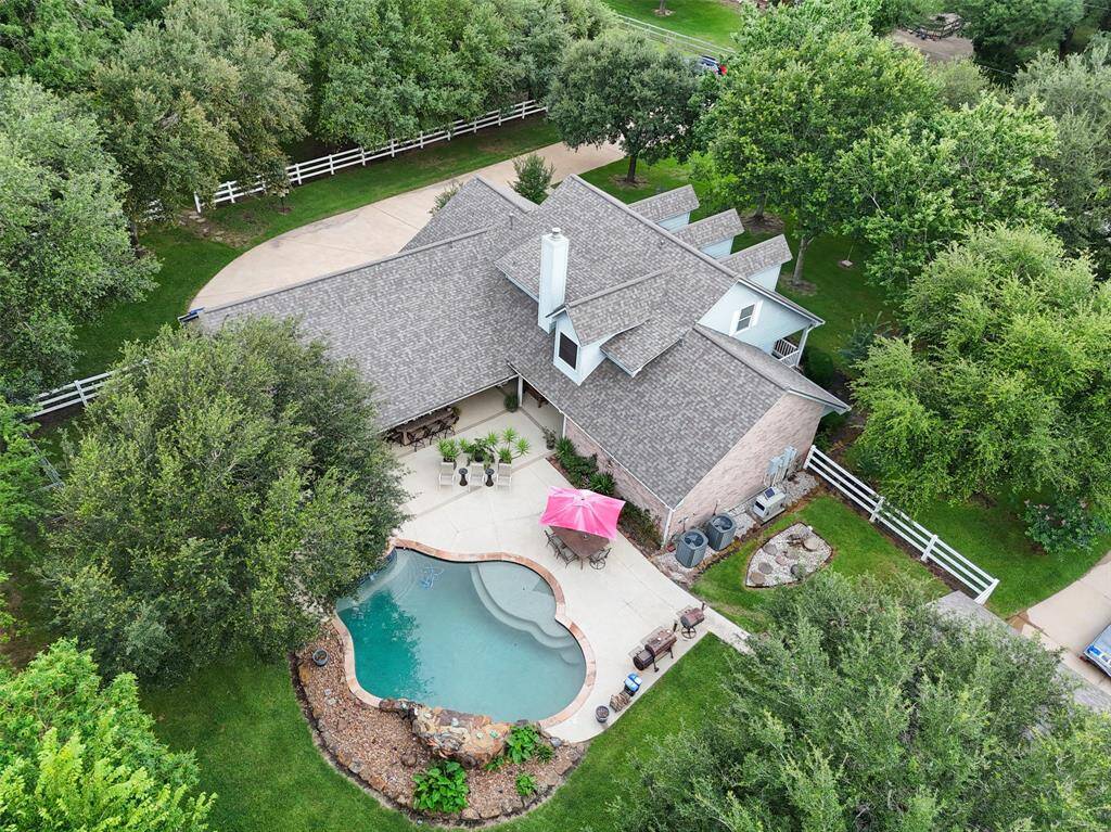 This fabulous home has it all; four spacious bedrooms, four and a half baths, both formals and open-concept casual living and dining areas, plus an updated kitchen designed for everyday ease. Step outside to your own backyard retreat with a covered summer kitchen, pool, spa, and pool house. A 30x40 steel building with workshop space adds even more versatility. The list goes on and on!