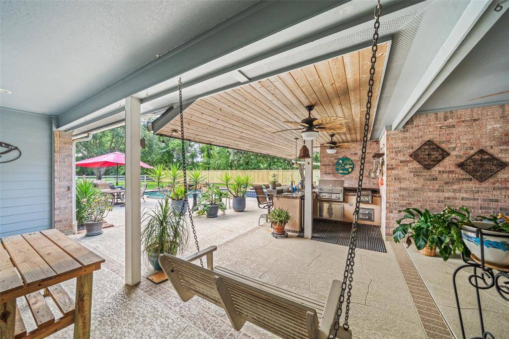 Whether you're hosting lively gatherings or unwinding after a long day, this backyard paradise has it all with a spacious covered patio, fully equipped summer kitchen, and a heated pool and spa that create the perfect setting for making memories and melting stress away.