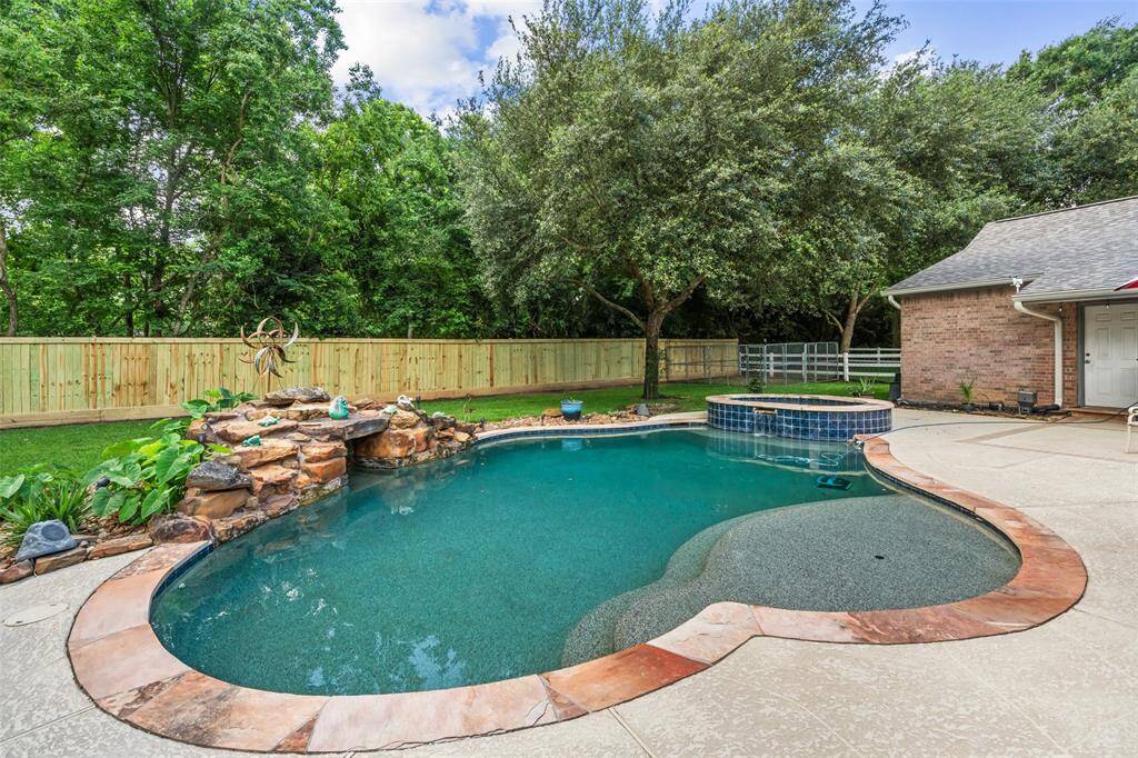This backyard oasis strikes the perfect balance between relaxation and entertainment, featuring a raised spa and sparkling pool with soothing rock and water features. Recently updated fencing enhances privacy while the spacious patio offers plenty of room for lounging, dining, and soaking up the Texas sun.