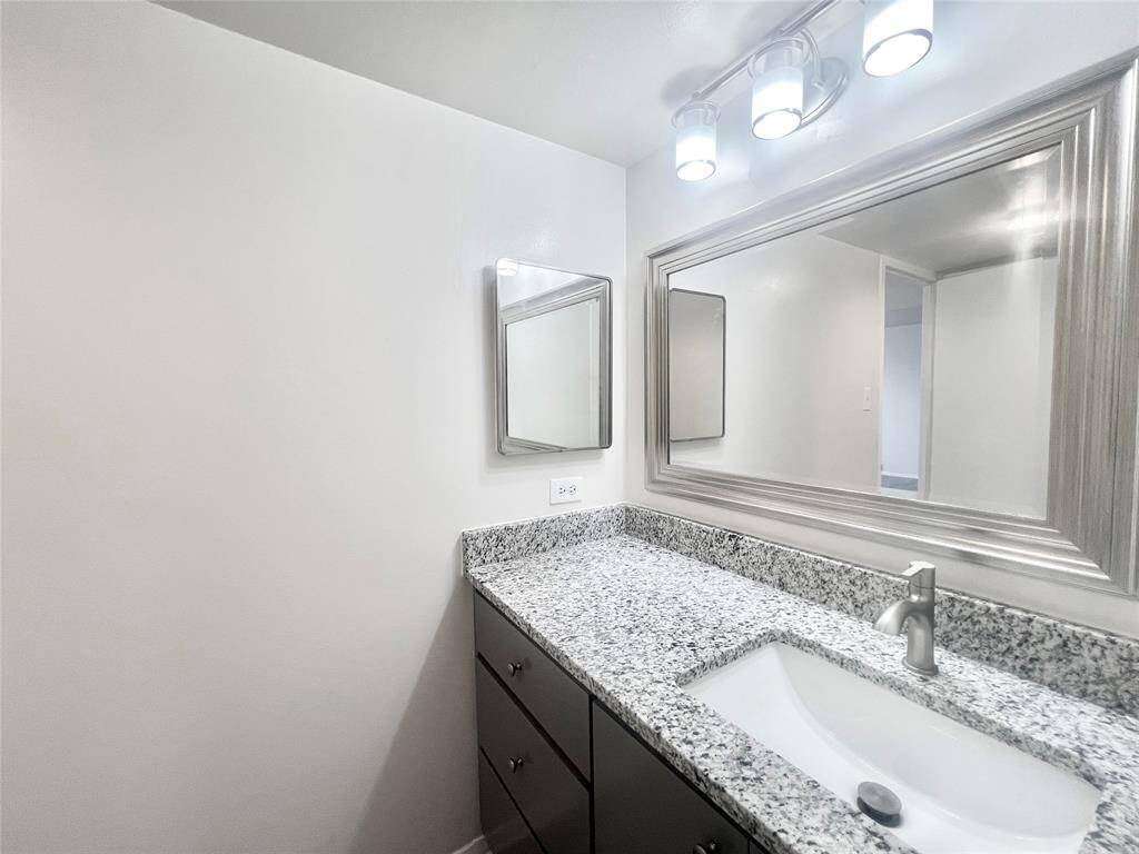 Vanity and bathroom area with 3 closets