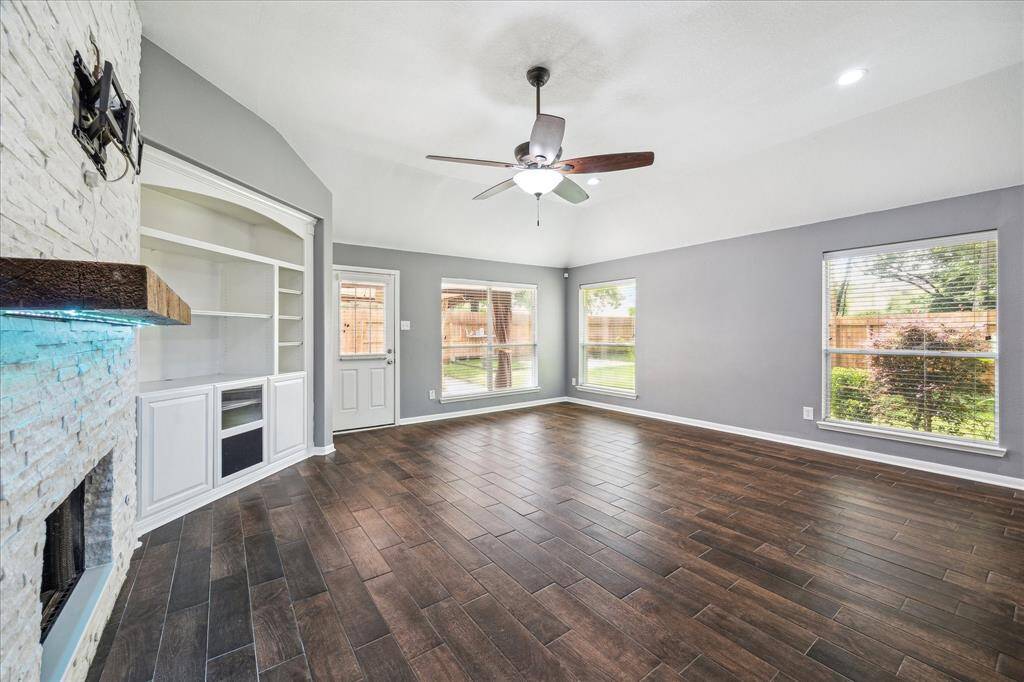 Ample living area with updated custom fireplace.