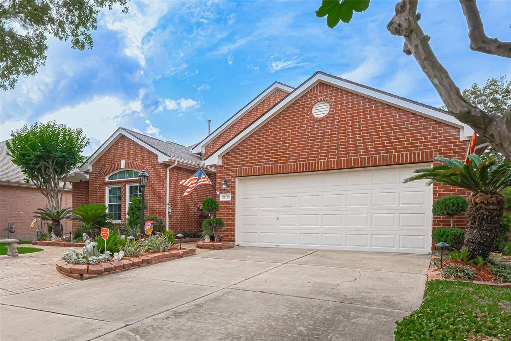 The two car garage, with long driveway, features a convenient lift inside, ensuring easy access and added functionality
