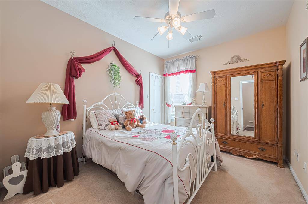 The second bedroom is spacious, offering plenty of natural light through its large window