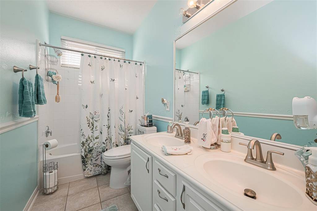 Conveniently located in the hallway between all three bedrooms, the guest bathroom offers easy access and features dual sinks for added comfort