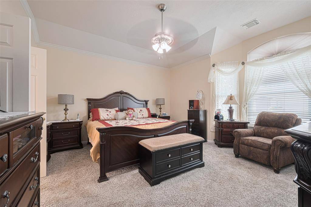 Enjoy peaceful backyard views and lush landscaping through sunlit windows in this relaxing retreat