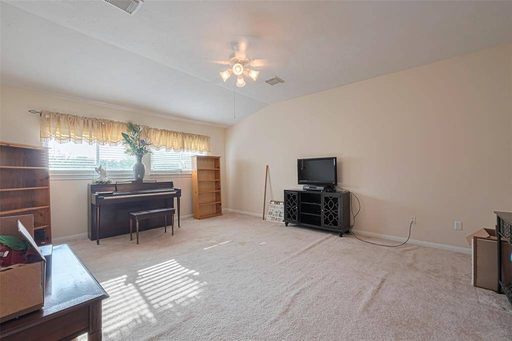 The upstairs flex room, versatile and bright, this room with large windows and a closet can easily serve as a game room, living room, or media room.