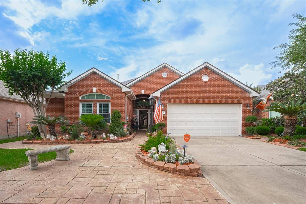 Award winning landscaping set the tone from the moment you arrive, enhanced by beautiful stamped pavers