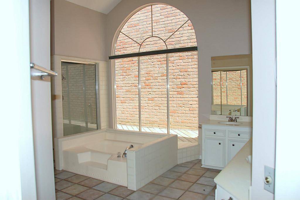 Oversized primary bathroom with dual sinks, soaking tub and separate shower.