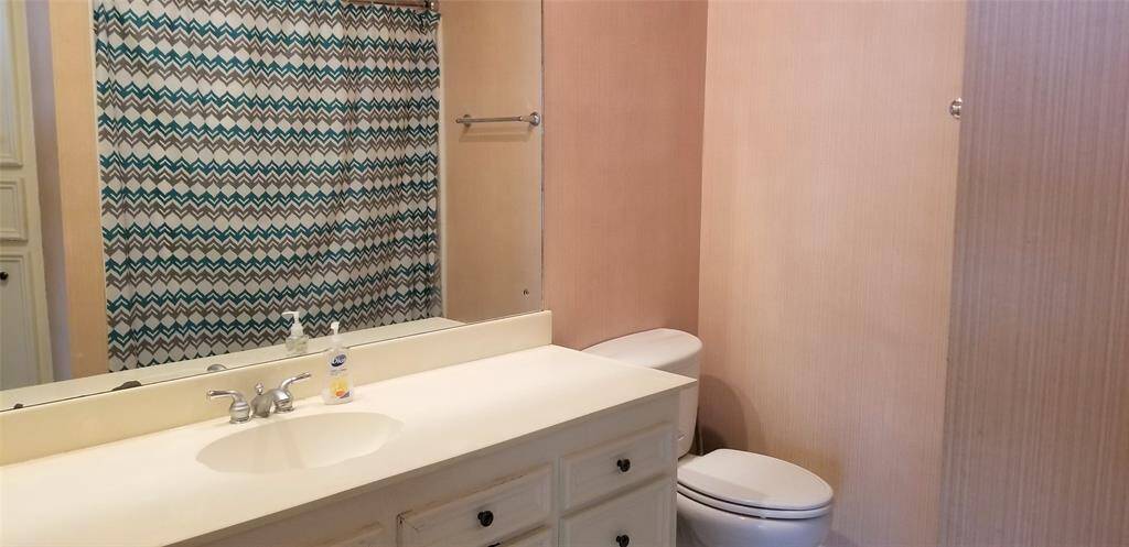 Full bath with tub and shower combination.