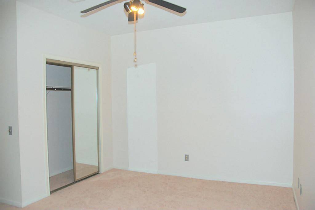 Bedroom 3 with carpeting and ceiling fan.