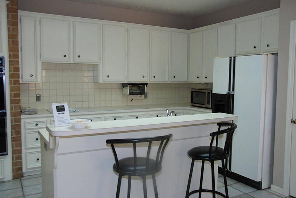 Kitchen with double ovens, dishwasher, electric cooktop.