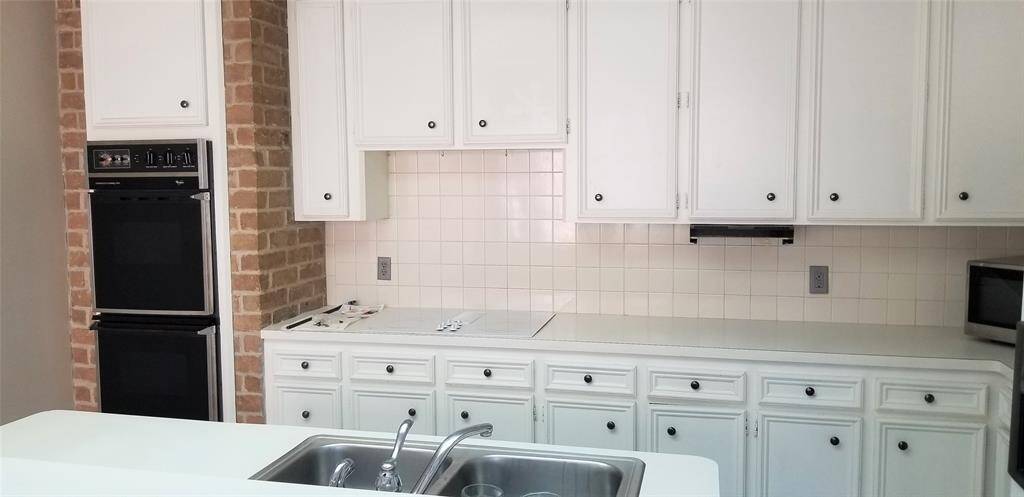 Kitchen with electric oven, double sinks. Photos are from before Tenants moved in.