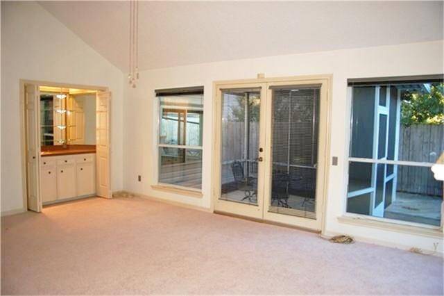 Alternate view of main living area. Wet bar. French doors lead to screened in porch and back yard.